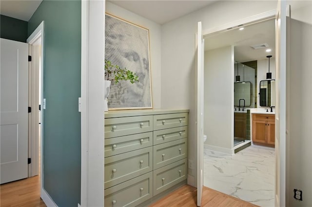 hallway with light hardwood / wood-style floors