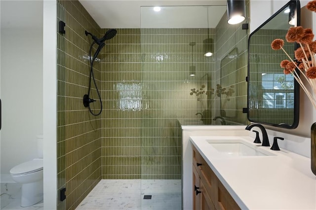 bathroom with vanity, toilet, and a shower with door