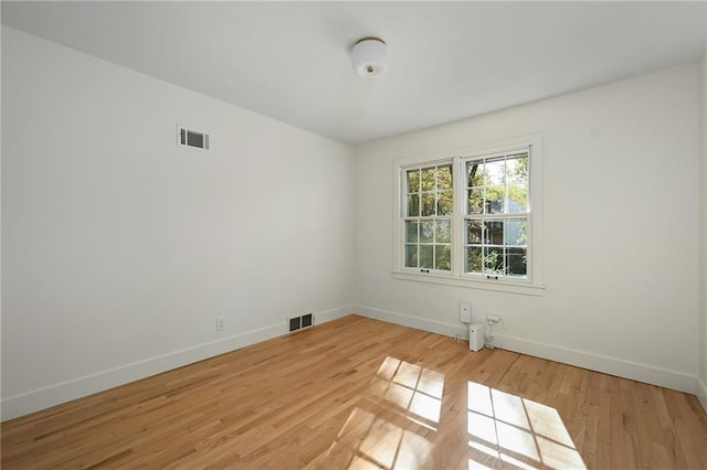 spare room featuring light hardwood / wood-style floors