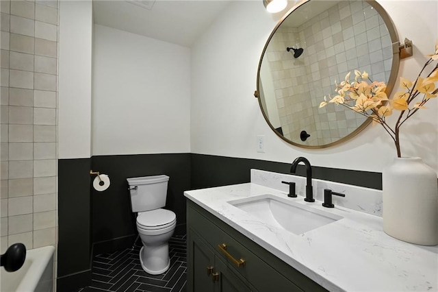 bathroom with tile patterned floors, vanity, and toilet