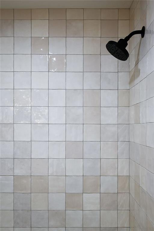 interior details featuring tiled shower