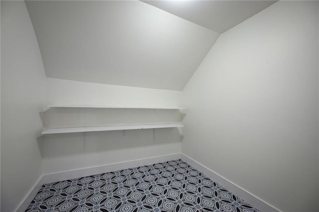 walk in closet with lofted ceiling