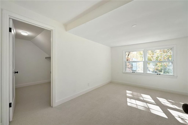 bonus room featuring lofted ceiling with beams and light colored carpet