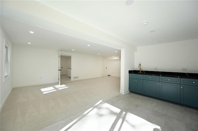 interior space featuring light colored carpet and sink