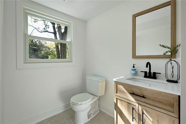 bathroom with tile patterned floors, vanity, and toilet