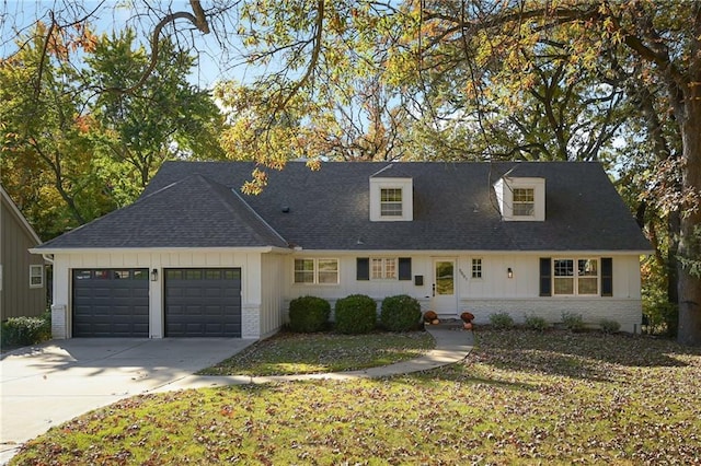 view of front of home with a garage and a front lawn