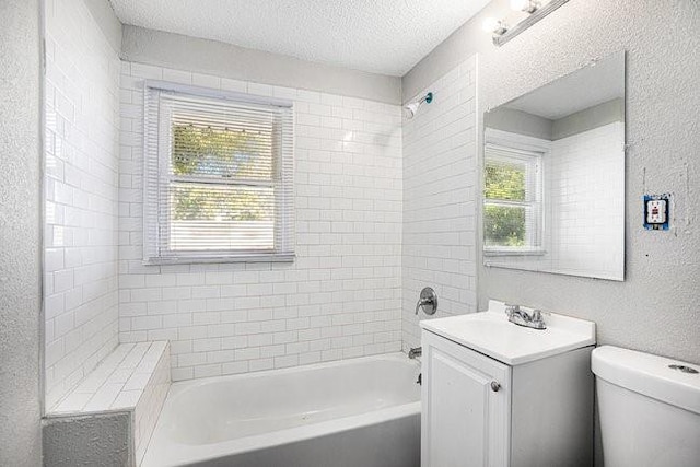 full bathroom featuring vanity, toilet, a healthy amount of sunlight, and a textured ceiling