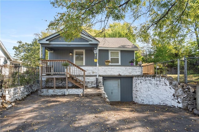 view of front of home featuring covered porch and a garage