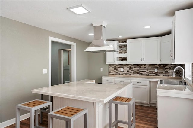 kitchen with custom range hood, sink, a kitchen bar, and a kitchen island