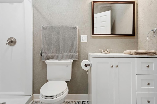 bathroom with vanity, toilet, and walk in shower