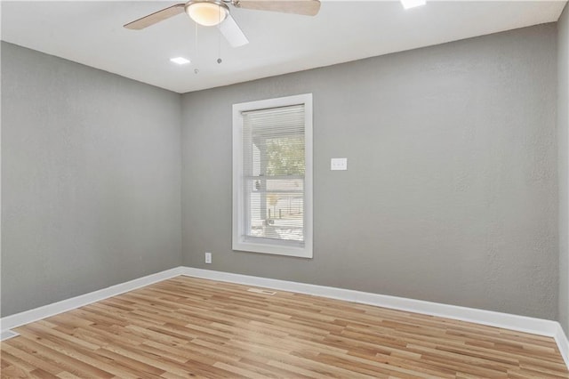 empty room with light wood-type flooring and ceiling fan