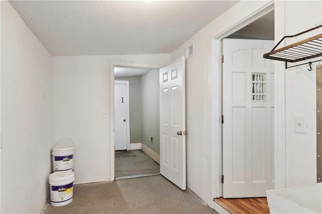 hallway featuring a textured ceiling