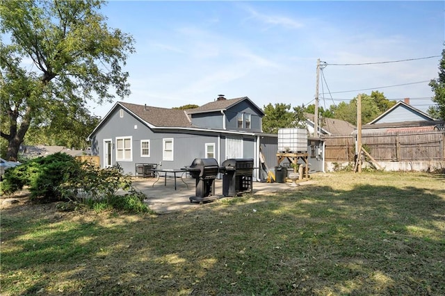 back of property featuring a yard and a patio