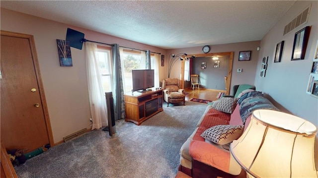 living room with a textured ceiling and carpet flooring