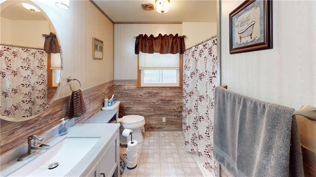 bathroom featuring vanity, toilet, walk in shower, and wooden walls