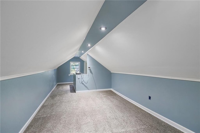 bonus room featuring carpet floors and vaulted ceiling