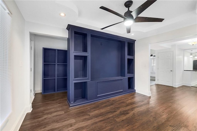 unfurnished living room with dark hardwood / wood-style floors and ceiling fan