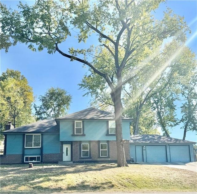 view of front facade with a front yard and a garage