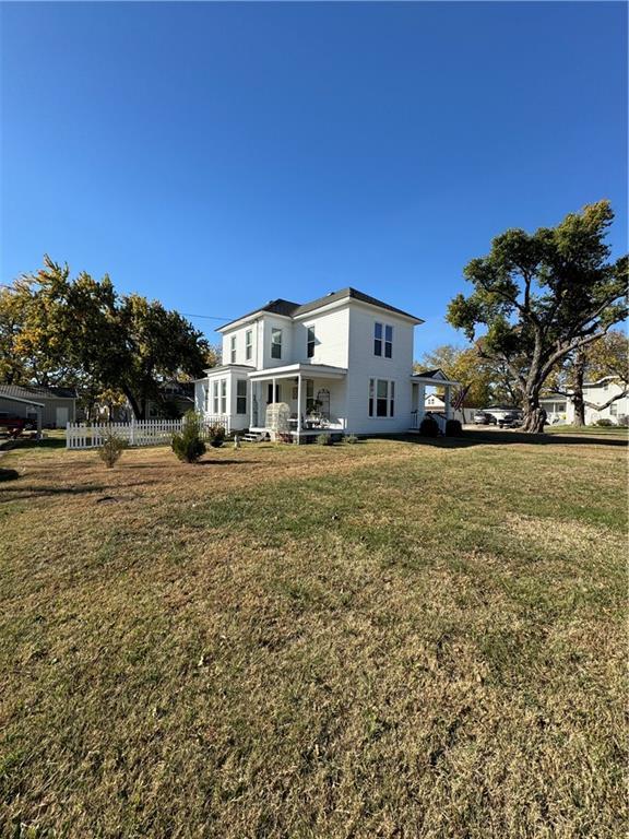 rear view of house featuring covered porch