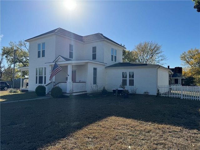 view of front of house featuring fence and a porch