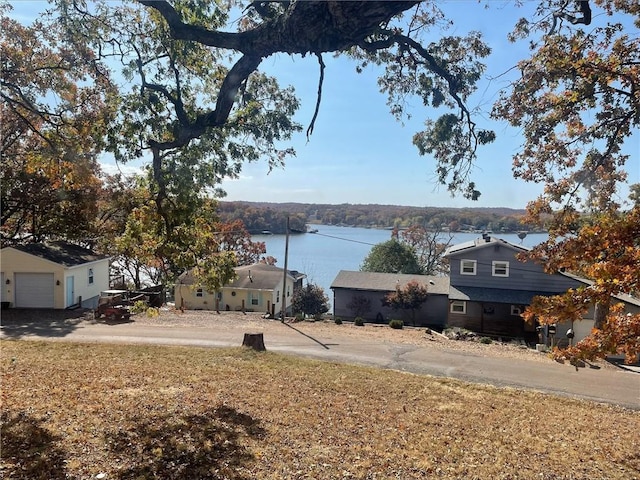 view of yard with a water view and a garage