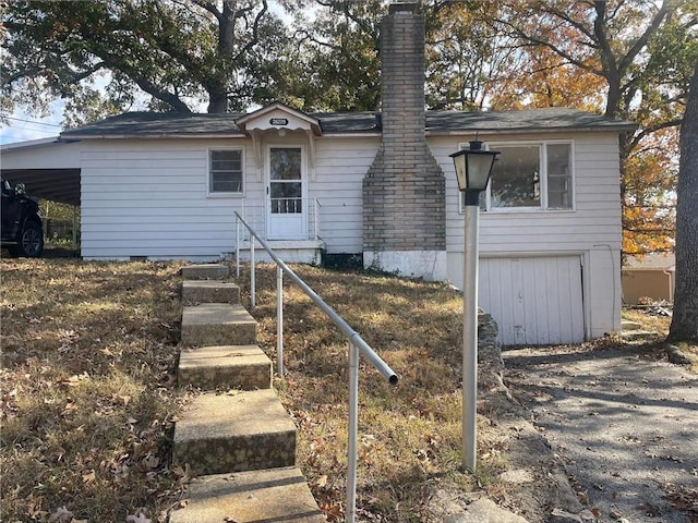 rear view of property with a carport