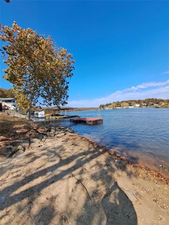 view of water feature featuring a dock and a view of the beach