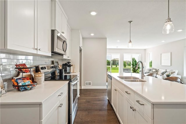 8701 SW Edgewater Dr, Blue Springs, MO 64064 - kitchen featuring stainless steel appliances, recessed lighting, dark wood-type flooring, backsplash, and light countertops