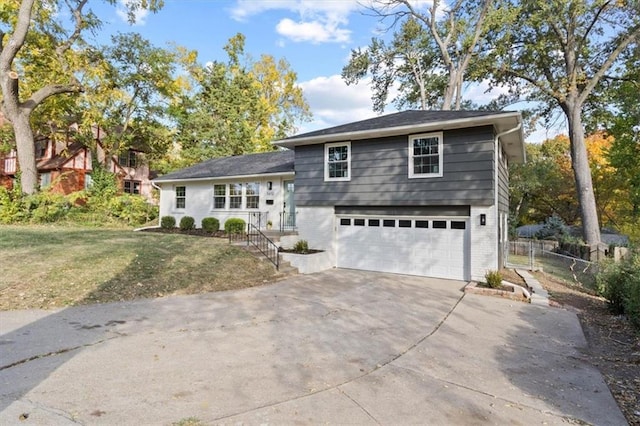 view of front of home with a front yard and a garage