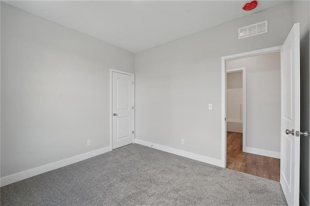 unfurnished bedroom featuring carpet flooring and baseboards