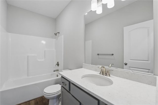 full bathroom featuring toilet, wood finished floors, vanity, and shower / bathtub combination