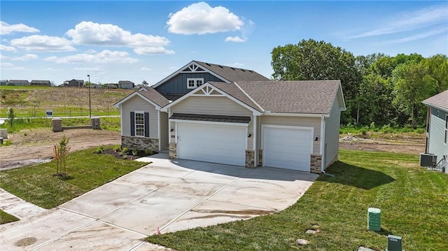 craftsman-style house with board and batten siding, stone siding, driveway, and a garage