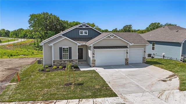 craftsman house featuring an attached garage, board and batten siding, concrete driveway, a front yard, and stone siding