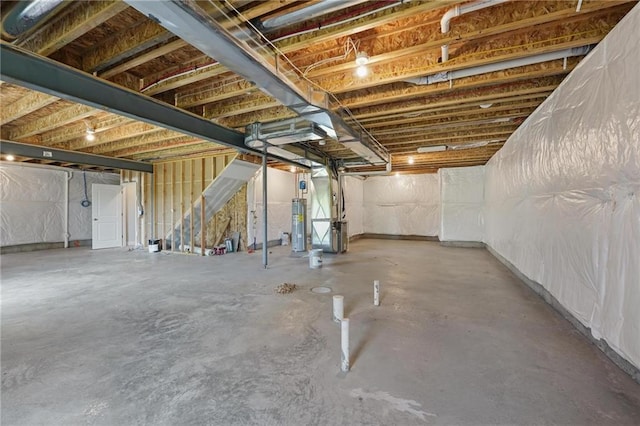 unfinished basement featuring water heater