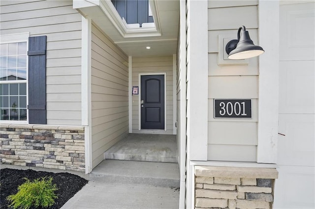 property entrance with stone siding