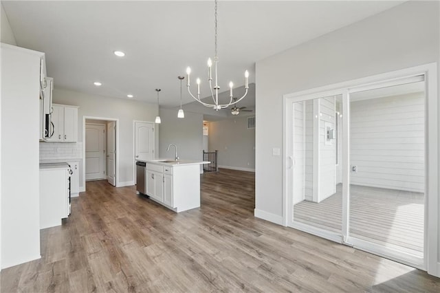 kitchen featuring a sink, appliances with stainless steel finishes, a chandelier, light countertops, and recessed lighting