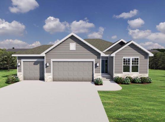 view of front of property with a front yard and a garage