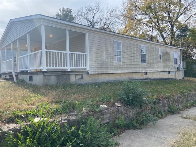 view of side of property with a sunroom