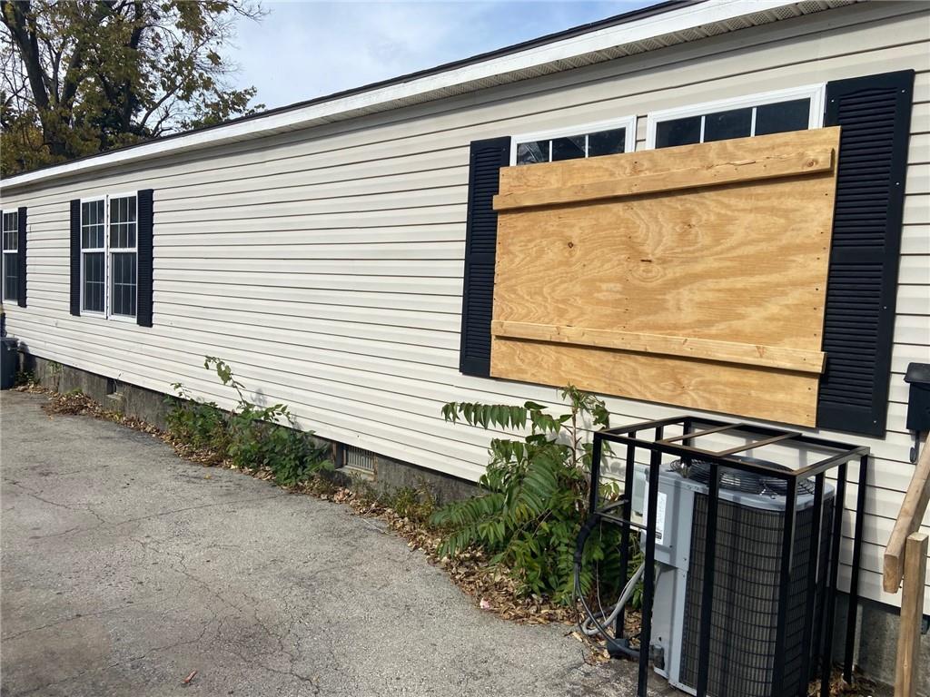 view of side of property with central air condition unit