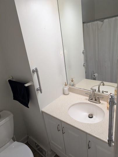 bathroom featuring toilet and vanity