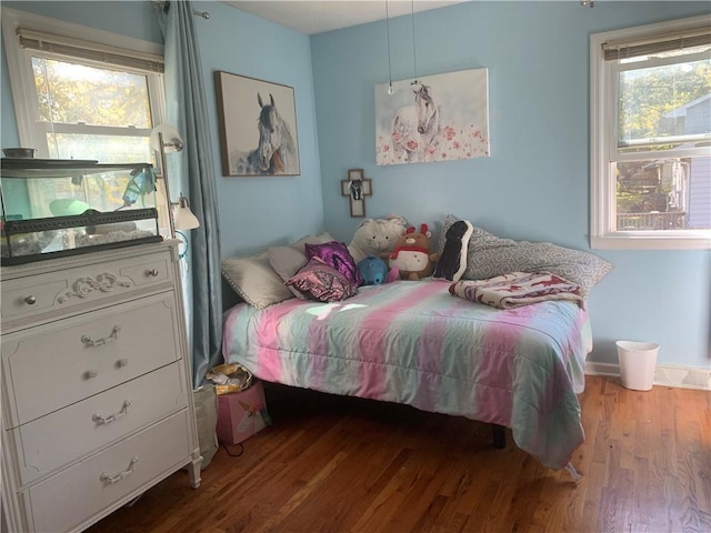 bedroom featuring hardwood / wood-style flooring and multiple windows