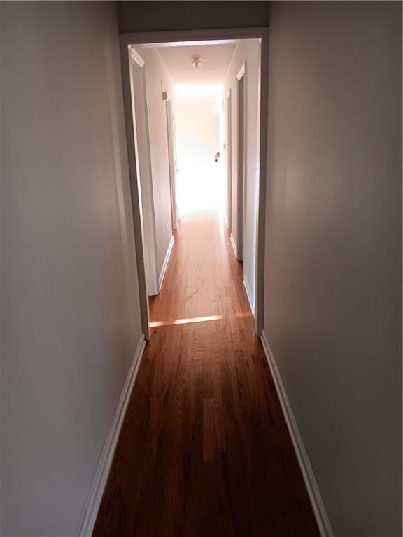 305 18th Ave N, Greenwood, MO 63034 - hall featuring baseboards and wood finished floors