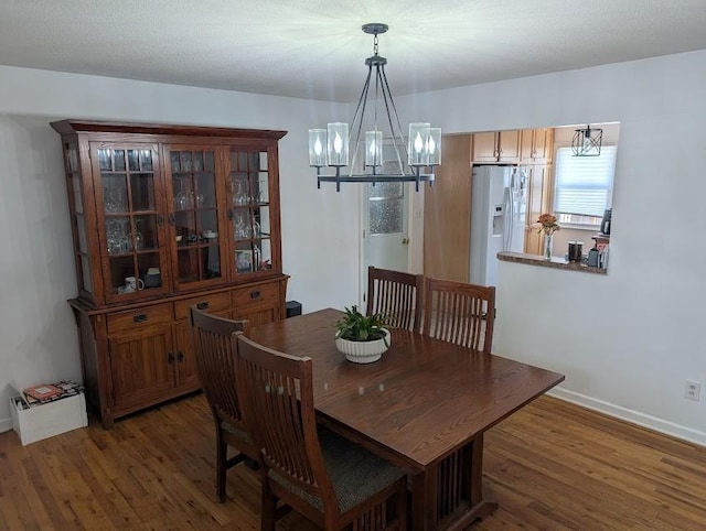 305 18th Ave N, Greenwood, MO 63034 - dining room featuring a chandelier, wood finished floors, and baseboards