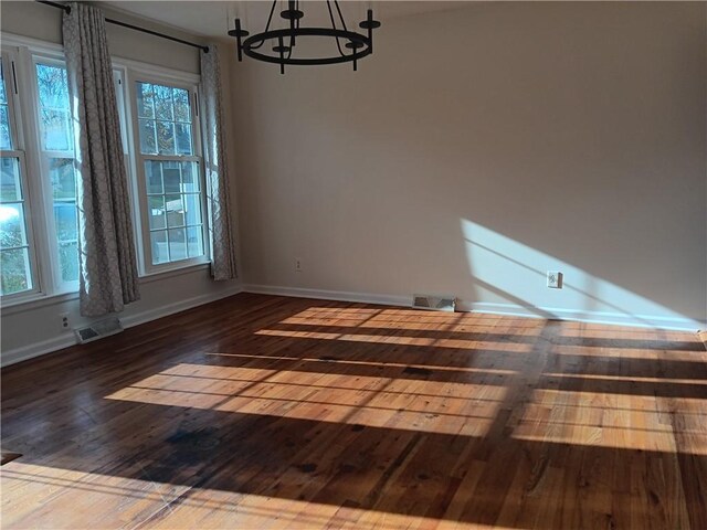 305 18th Ave N, Greenwood, MO 63034 - unfurnished dining area featuring a chandelier, a wealth of natural light, visible vents, and hardwood / wood-style floors