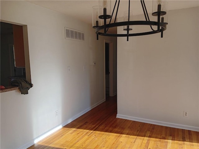 305 18th Ave N, Greenwood, MO 63034 - interior space with a chandelier, visible vents, hardwood / wood-style flooring, and baseboards