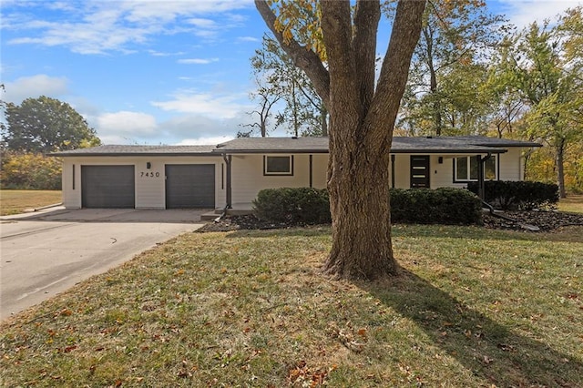 ranch-style house featuring a front yard and a garage