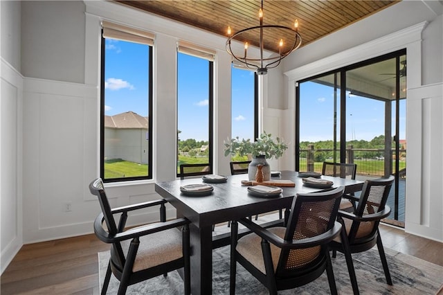 sunroom / solarium featuring wood ceiling, a notable chandelier, and a wealth of natural light