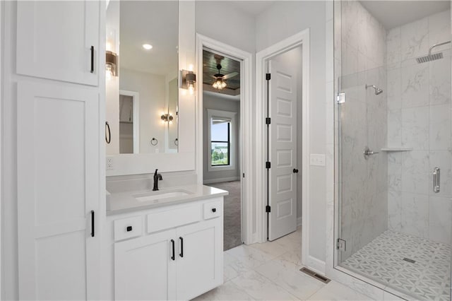 bathroom featuring a shower with door, ceiling fan, and vanity