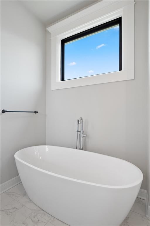 bathroom featuring a tub to relax in