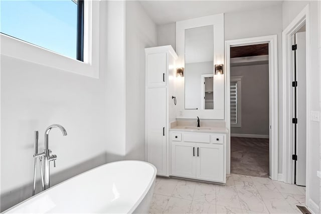 bathroom featuring vanity and a washtub